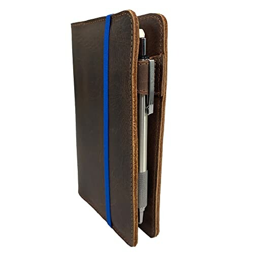 Brown leather notebook cover with pen holder and blue elastic band.