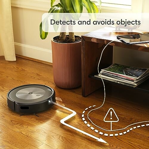 Robot vacuum cleaner navigating around obstacles on wooden floor.