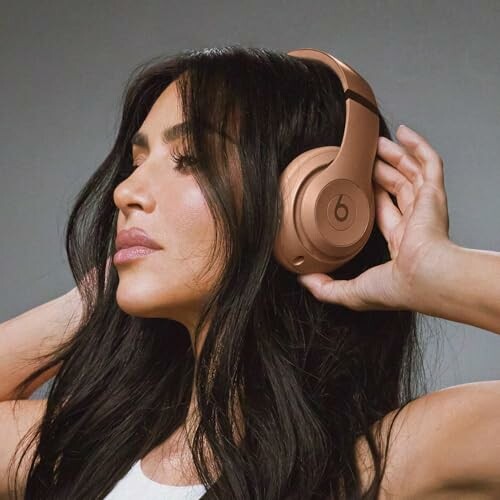 Woman wearing bronze headphones